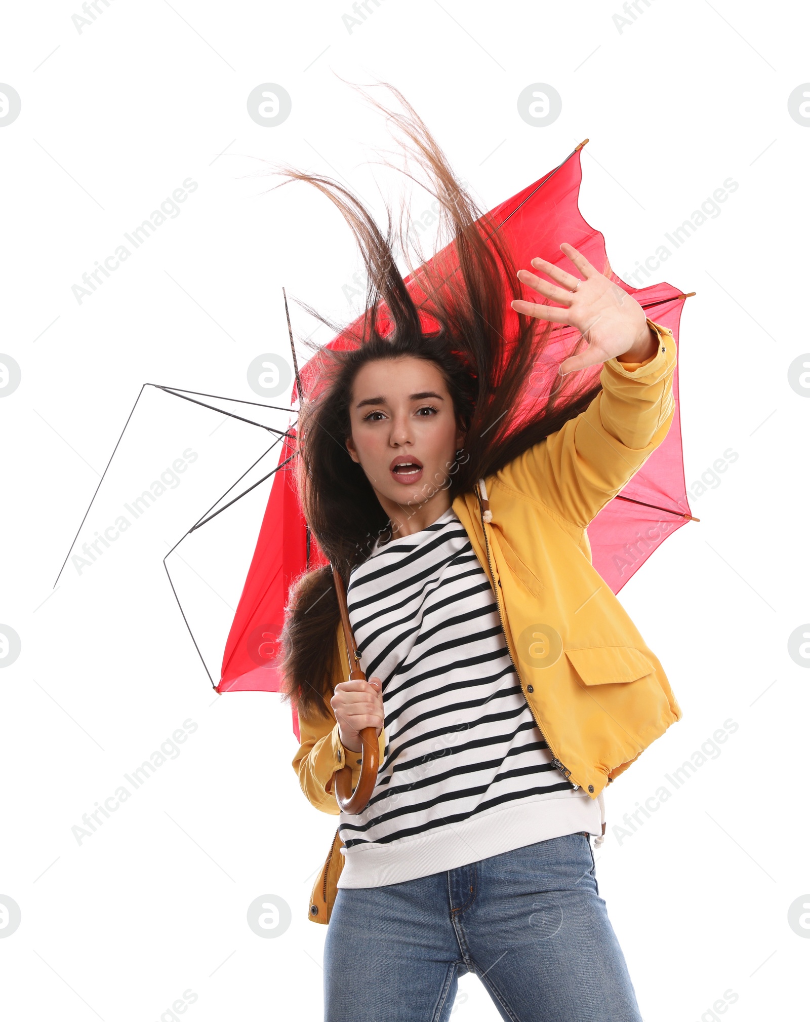 Photo of Emotional woman with umbrella caught in gust of wind on white background