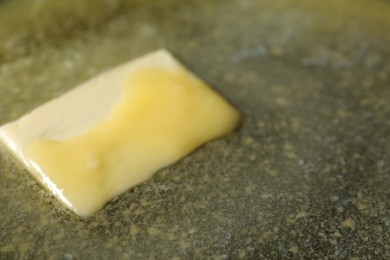 Photo of Tasty melting butter, closeup view. Space for text