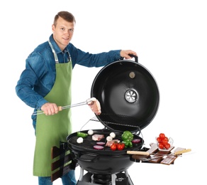 Man in apron cooking on barbecue grill, white background