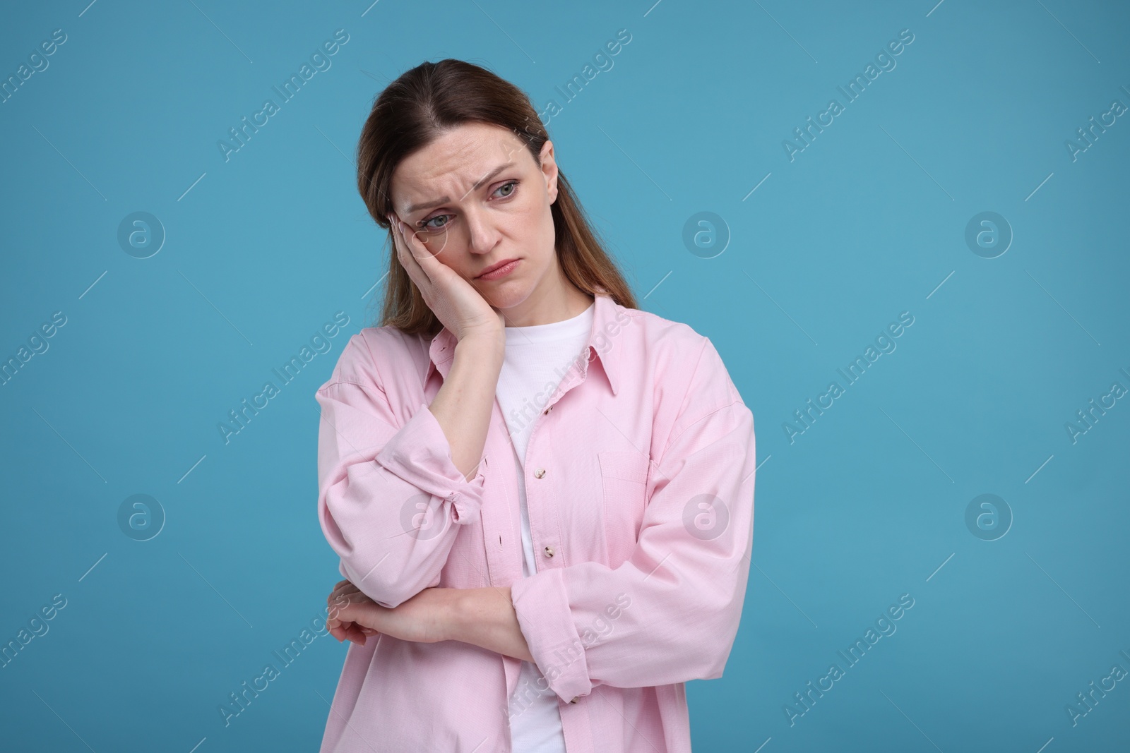 Photo of Portrait of sad woman on light blue background