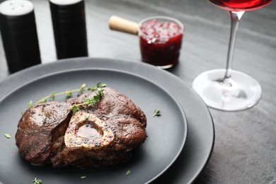 Photo of Tasty grilled beef meat served on black table, closeup