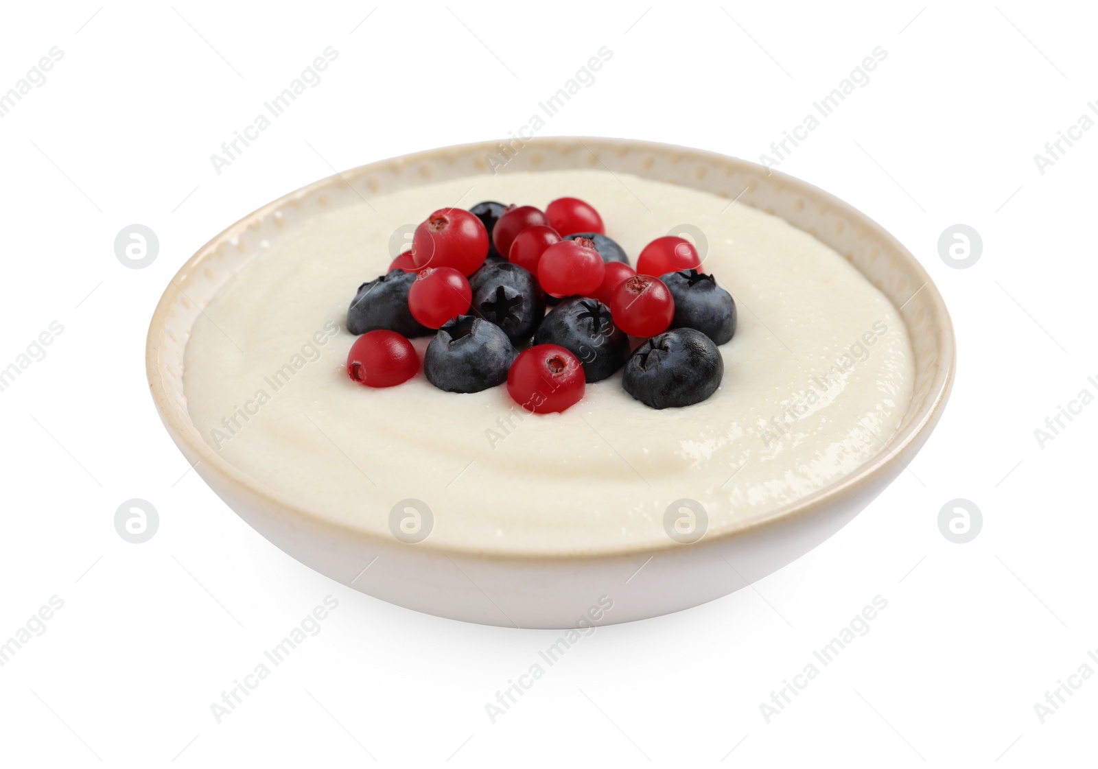 Photo of Delicious semolina pudding with berries isolated on white