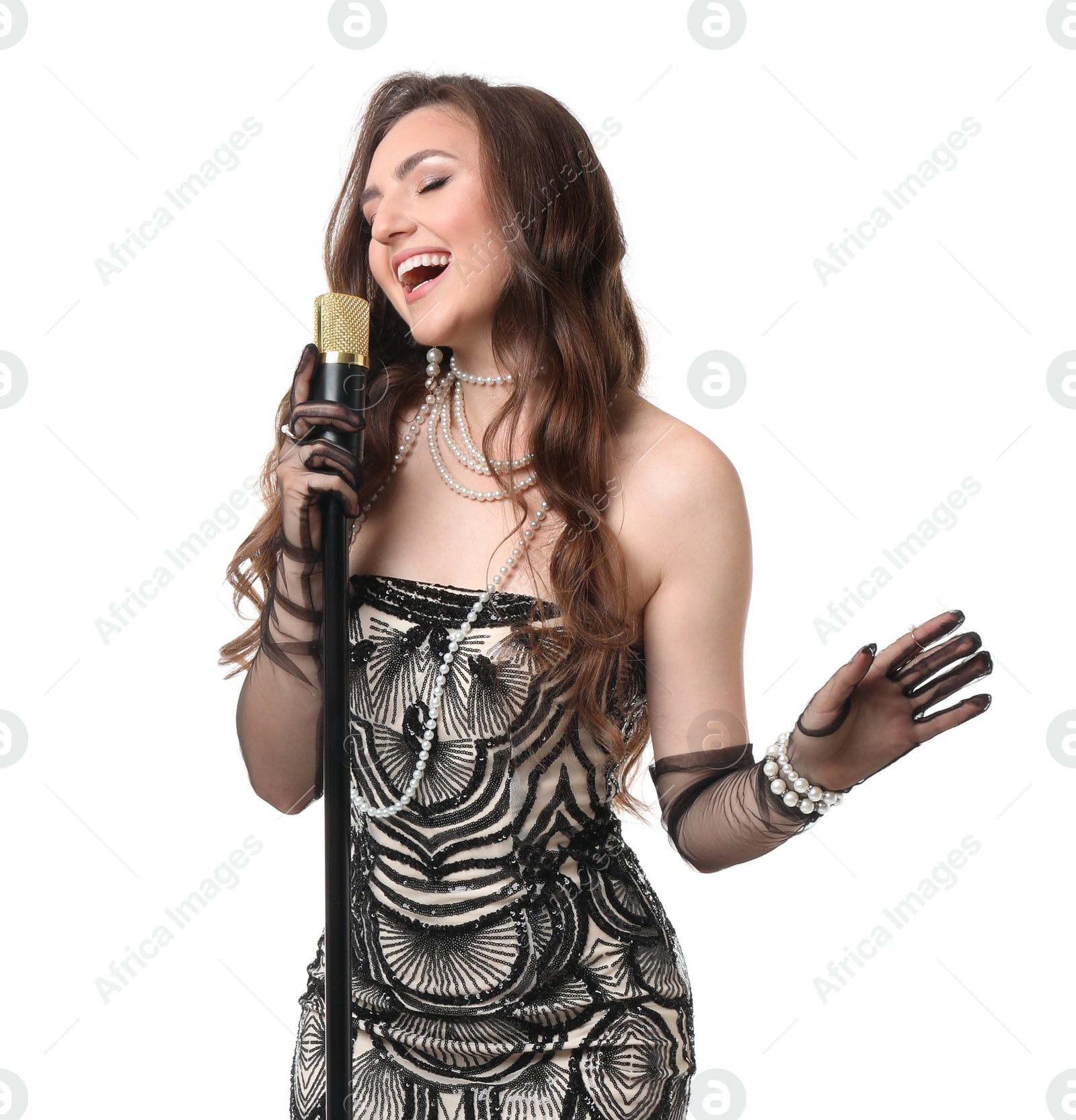 Photo of Beautiful young woman in stylish dress with microphone singing on white background