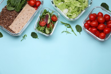 Glass containers with different fresh products on light blue background, flat lay. Space for text