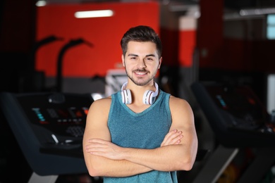 Handsome young man with headphones at gym