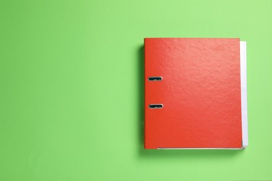 Photo of Red office folder on light green background, top view
