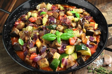 Photo of Delicious ratatouille in baking dish served on table, closeup