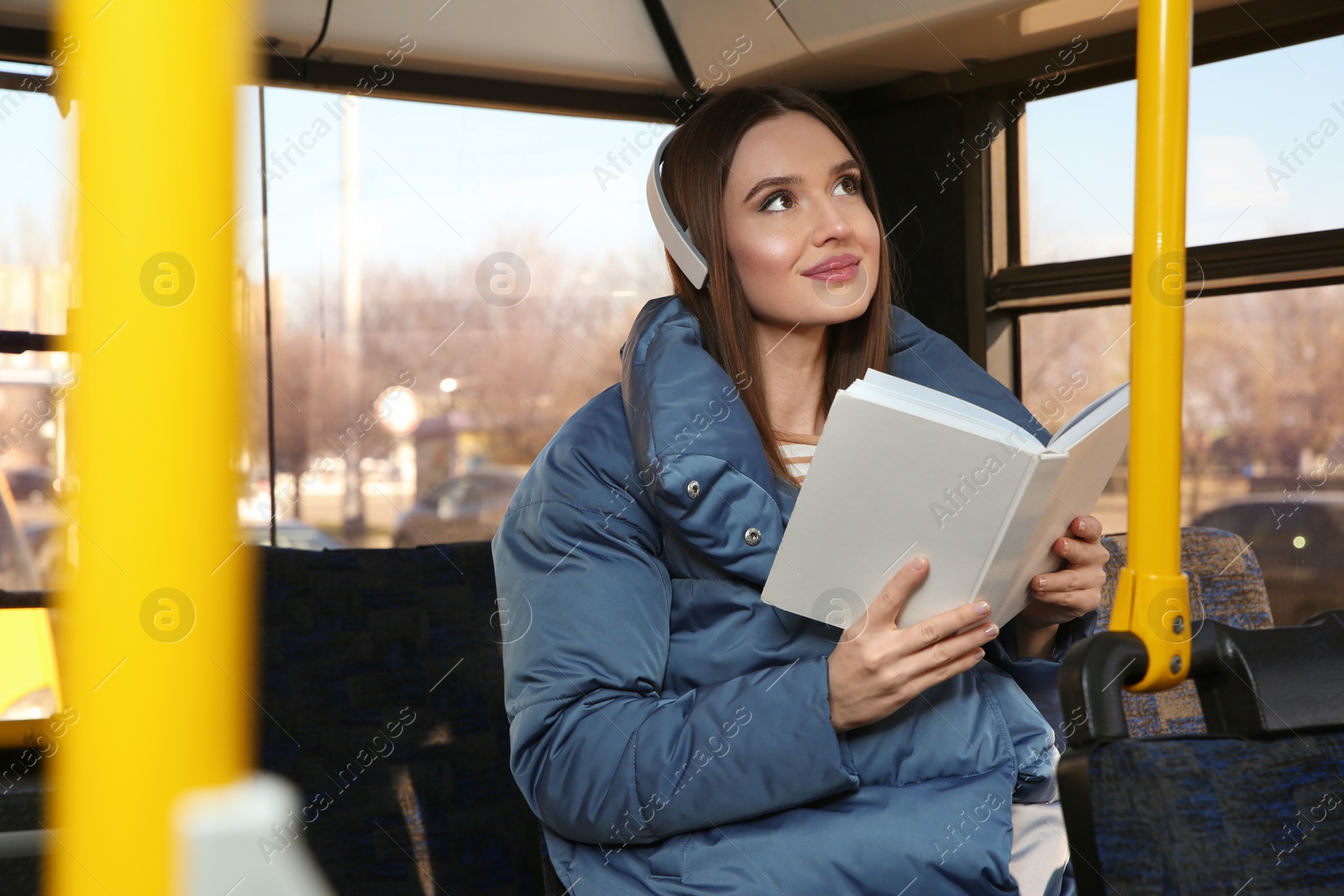 Photo of Woman listening to audiobook in trolley bus