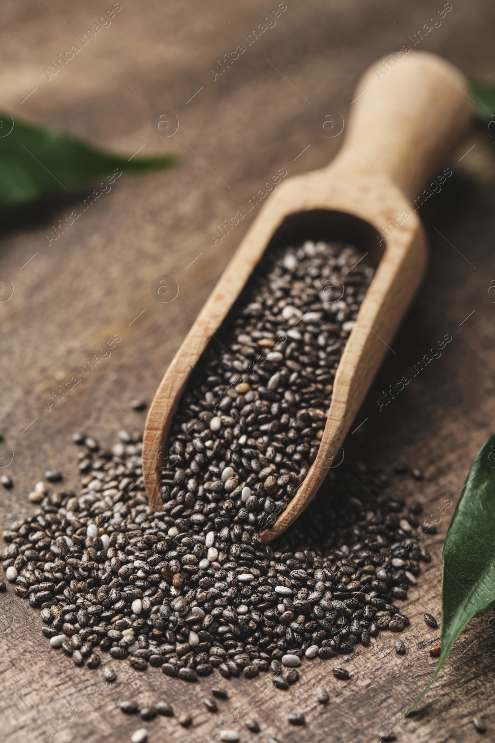 Photo of Scoop with chia seeds on wooden table