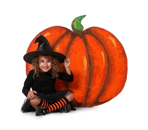 Cute little girl wearing Halloween costume and decorative pumpkin on white background