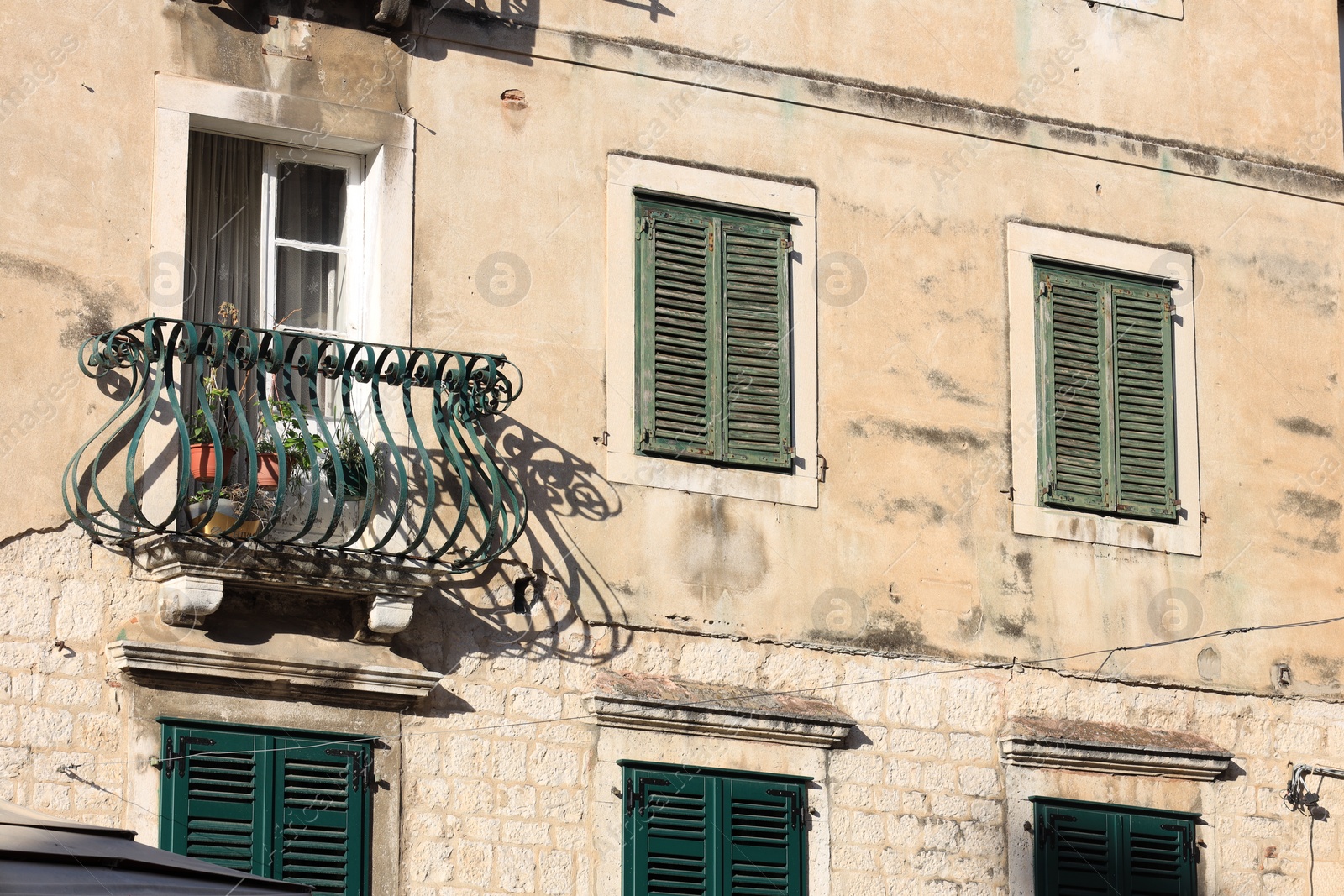 Photo of Exterior of old residential building with balcony