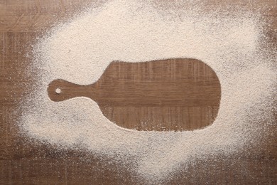 Photo of Imprint of board on wooden table with flour, top view