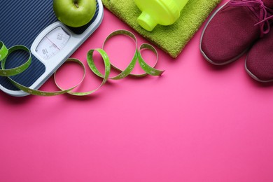 Flat lay composition with scales and measuring tape on pink background, space for text