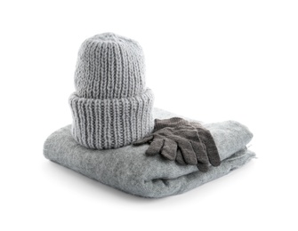 Photo of Woolen gloves, scarf and hat on white background