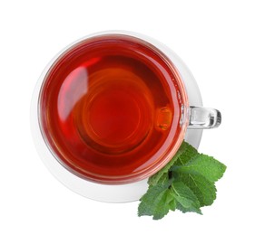 Cup of aromatic black tea with fresh mint on white background, top view