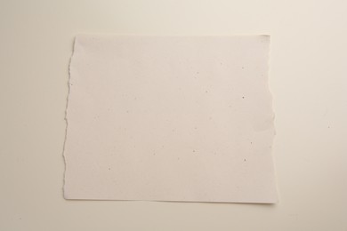 Photo of Sheet of parchment paper on beige background, top view