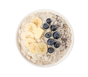 Photo of Tasty boiled oatmeal with banana, blueberries, chia seeds and butter in bowl isolated on white, top view
