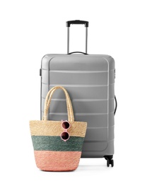 Photo of Gray suitcase and bag packed for journey on white background