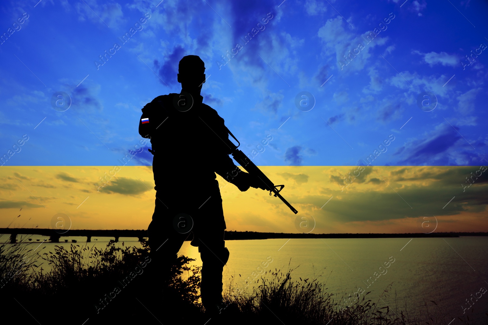 Image of Russian invasion of Ukraine. Silhouette of armed soldier from Russia outdoors, toned in colors of Ukrainian flag