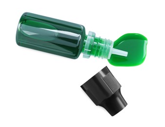 Photo of Bottle of green food coloring on white background, top view