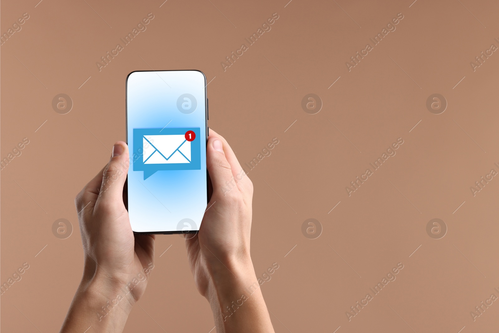 Image of New message notification. Man with mobile phone on dark beige background, closeup