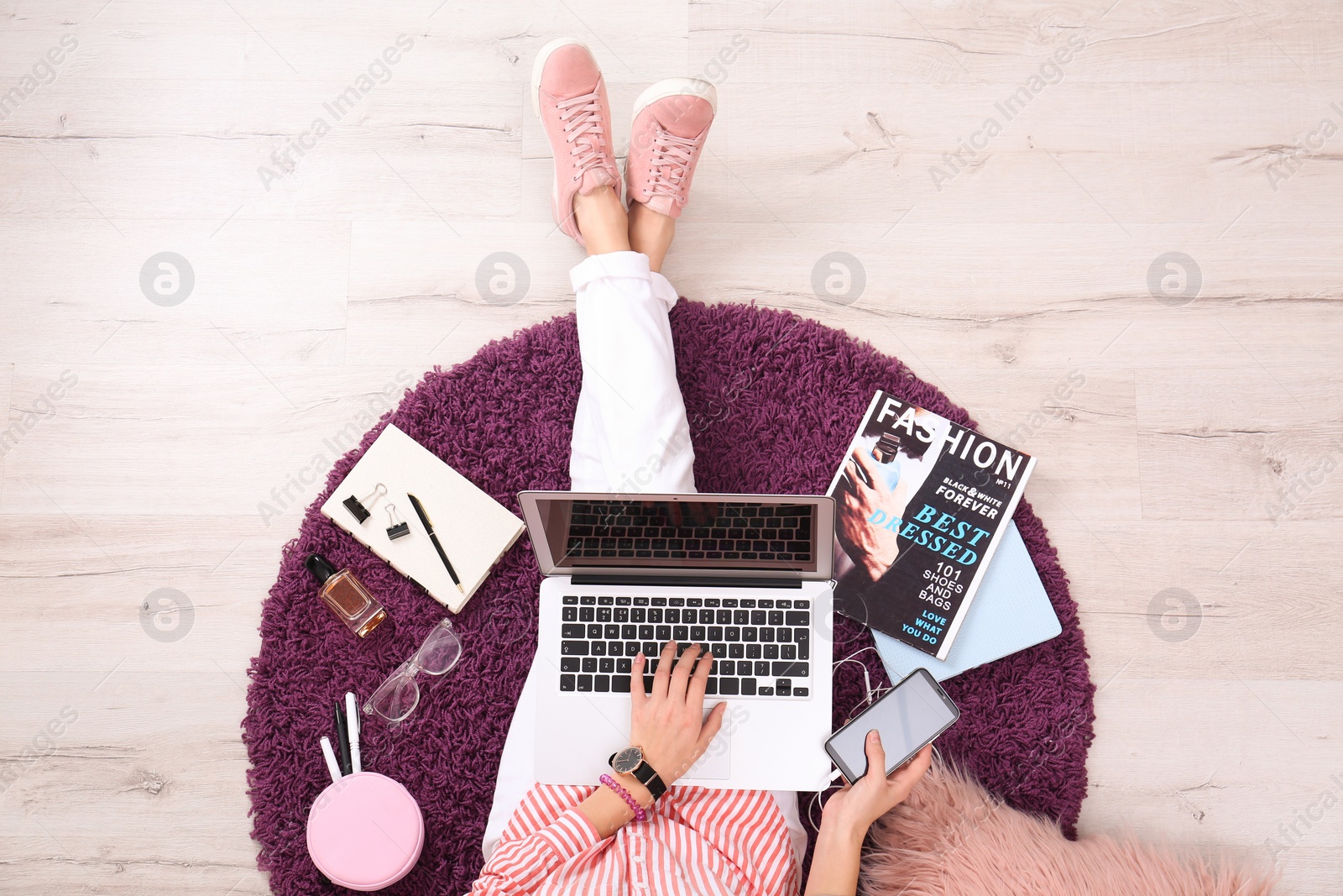 Photo of Fashion blogger with laptop sitting on floor, top view