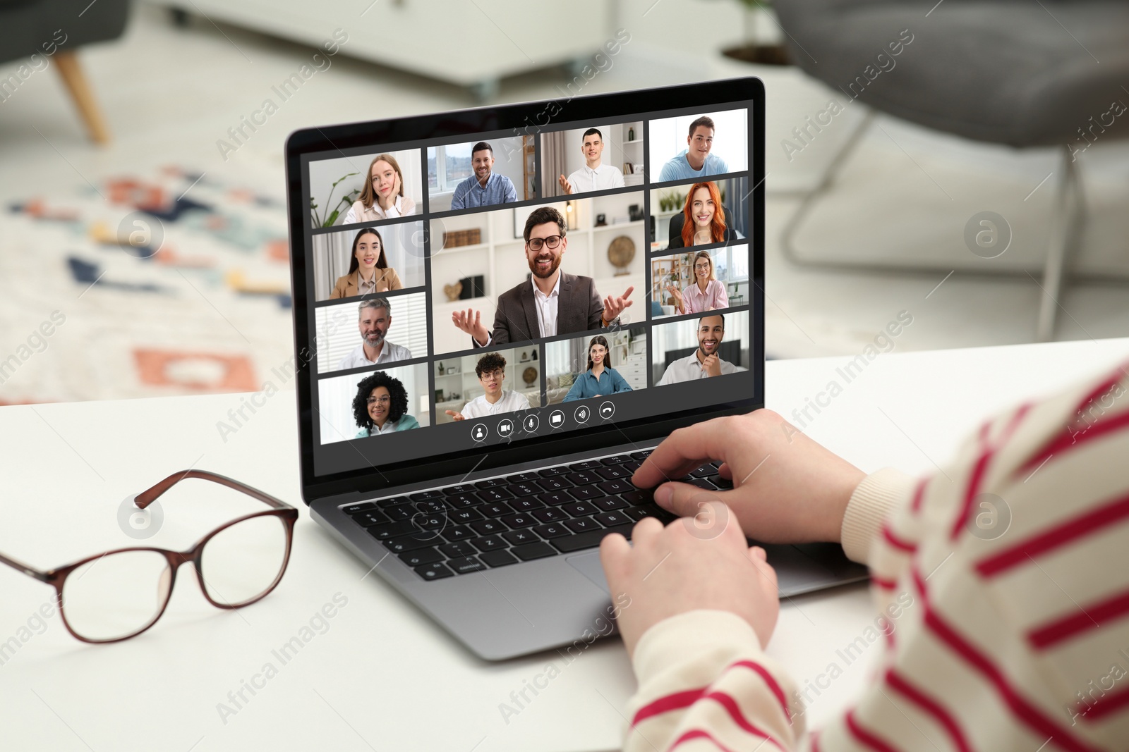 Image of Woman having video chat with coworkers via laptop at white table, closeup