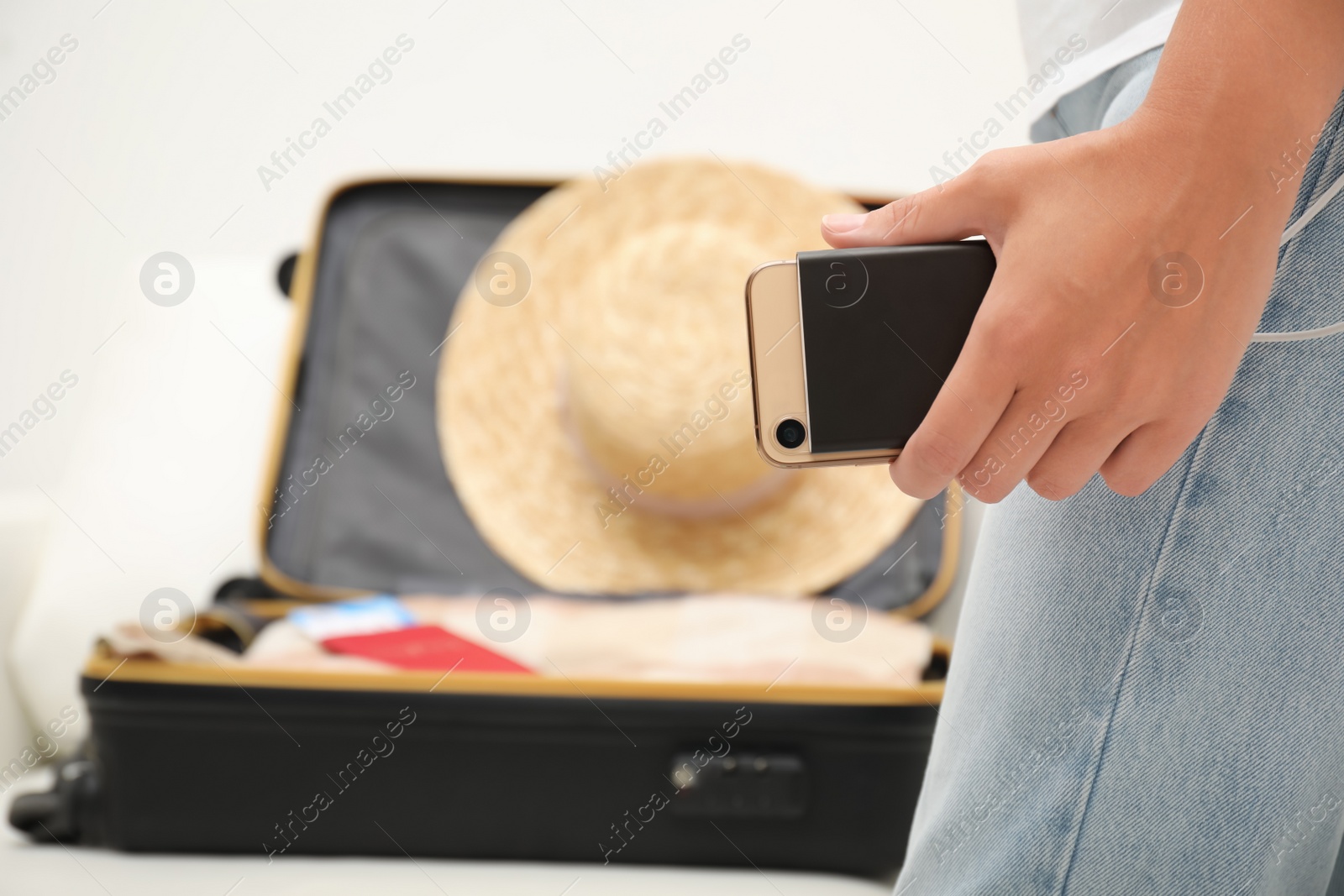 Photo of Woman charging smartphone with power bank indoors, closeup. Space for text