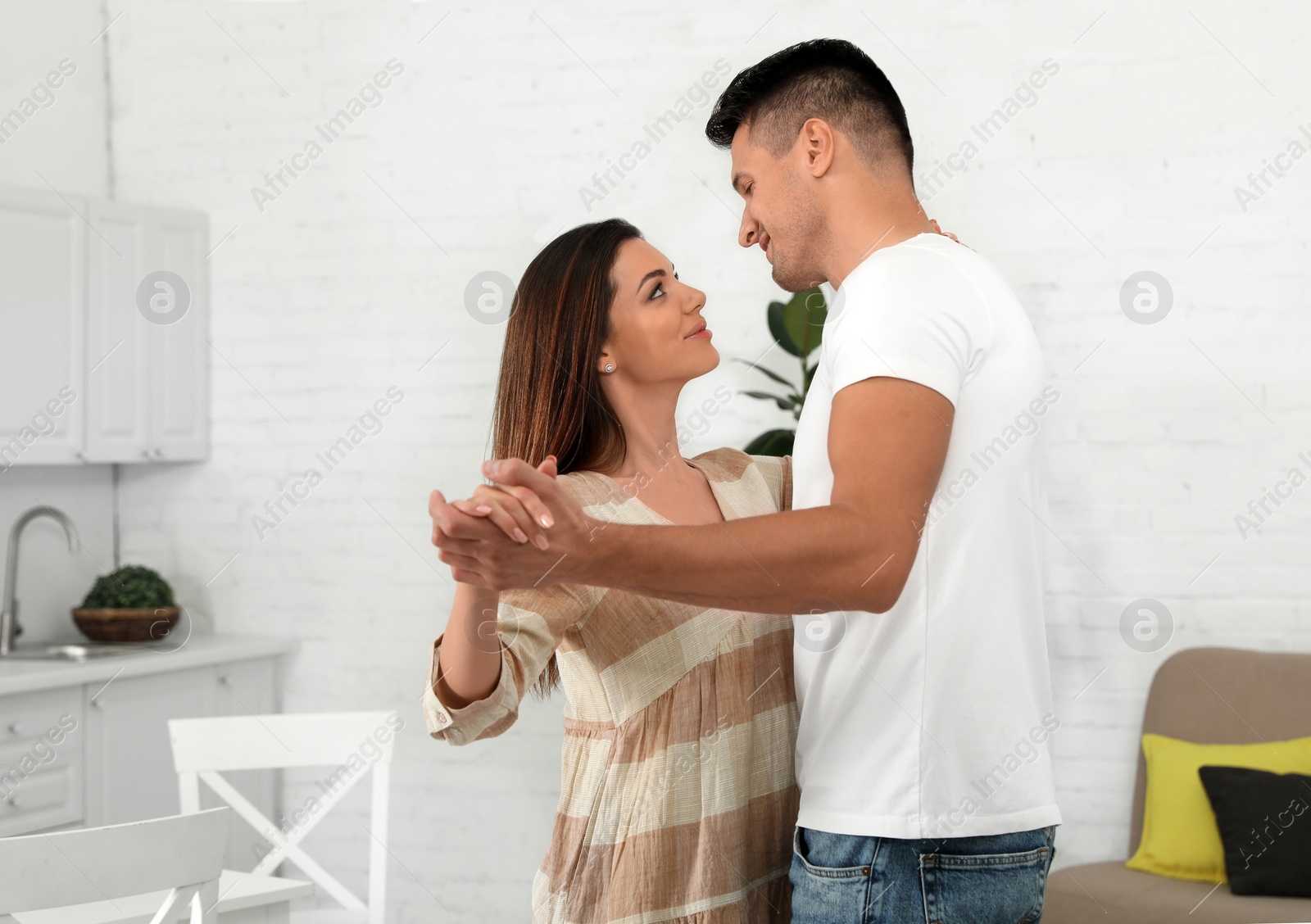 Photo of Happy couple dancing in kitchen at home