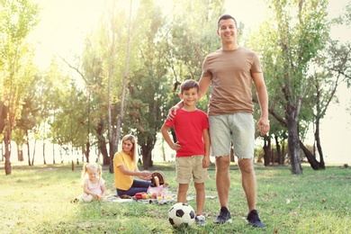 Photo of Happy family having picnic in park on sunny day