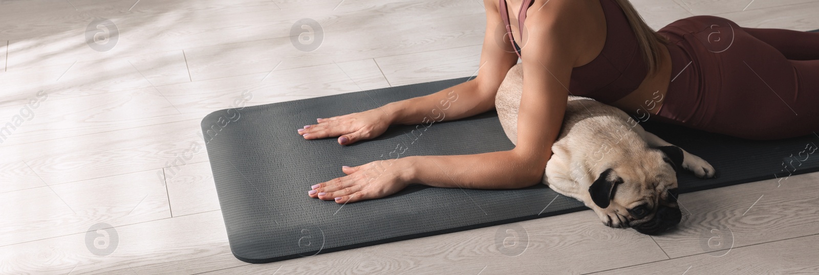 Image of Woman with dog practicing yoga at home. Horizontal banner design 