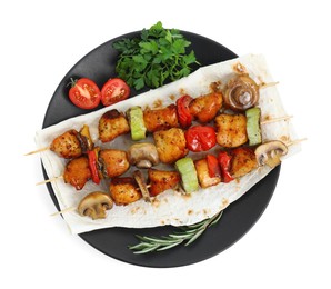 Delicious shish kebabs with vegetables and spices isolated on white, top view