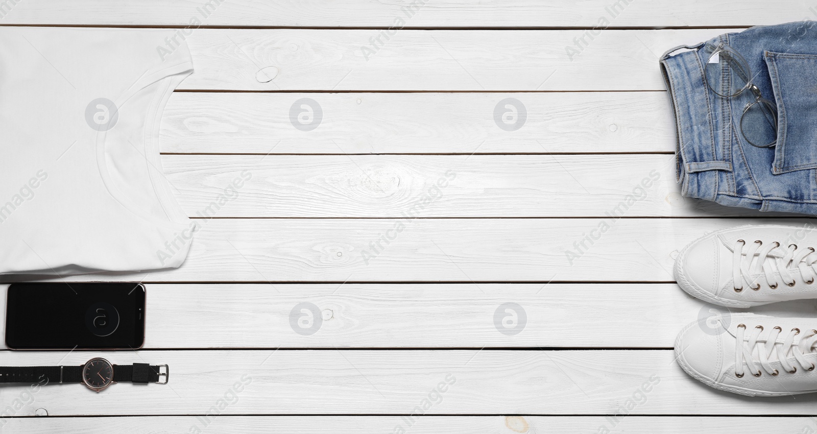 Photo of Stylish clothes and accessories on white wooden background, flat lay. Space for text