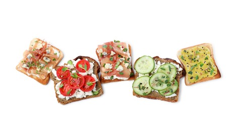 Different delicious sandwiches with microgreens on white background, top view