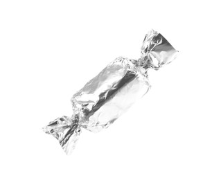 Photo of Tasty candy in silver wrapper isolated on white