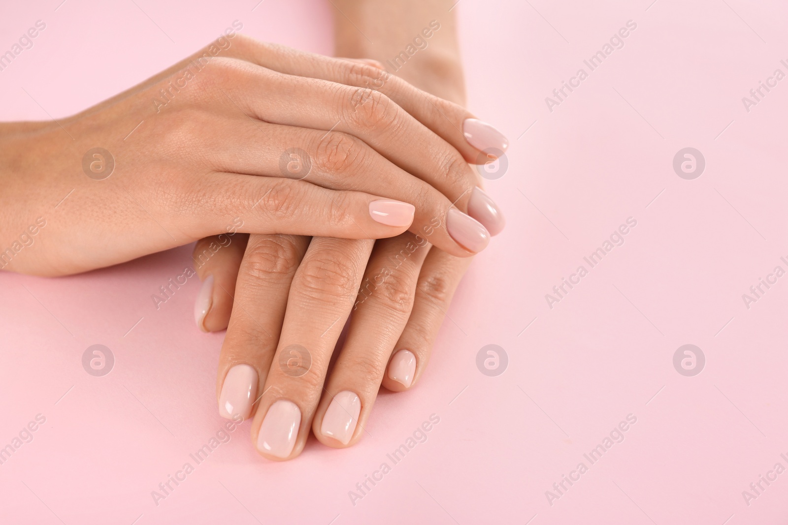 Photo of Closeup view of woman with beautiful hands on color background, space for text. Spa treatment