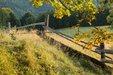 Wooden fence in countryside on sunny day