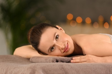 Beautiful young woman relaxing in spa salon