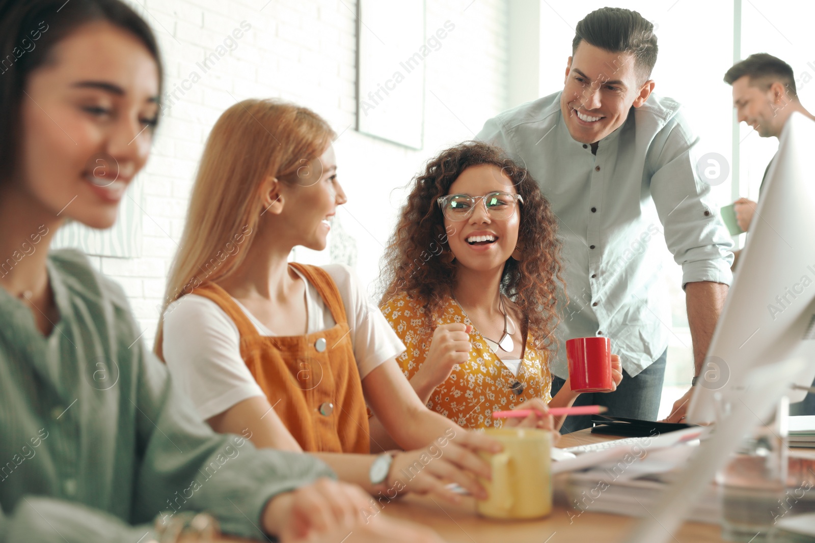 Photo of Team of professional designers working in office