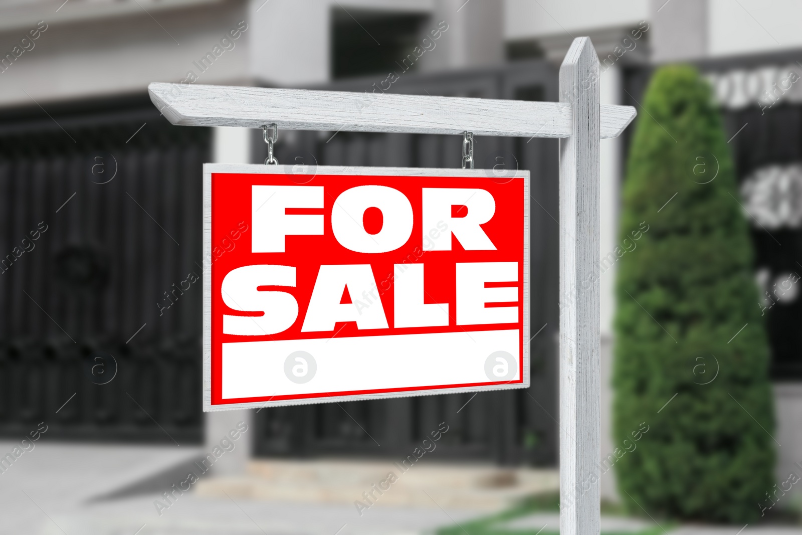 Image of Sale sign near beautiful house outdoors. Red signboard with words