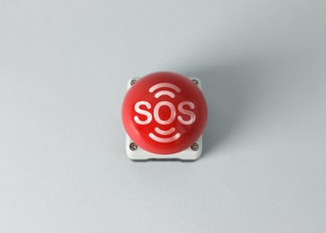 Image of Red SOS button on white background. Space for text