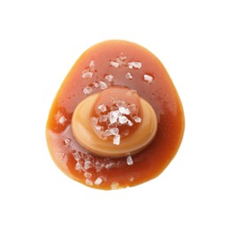 Photo of Yummy candy with caramel sauce and sea salt isolated on white, top view