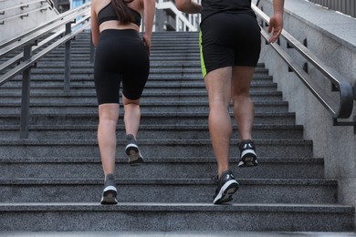 Photo of Healthy lifestyle. Couple running up steps outdoors, closeup