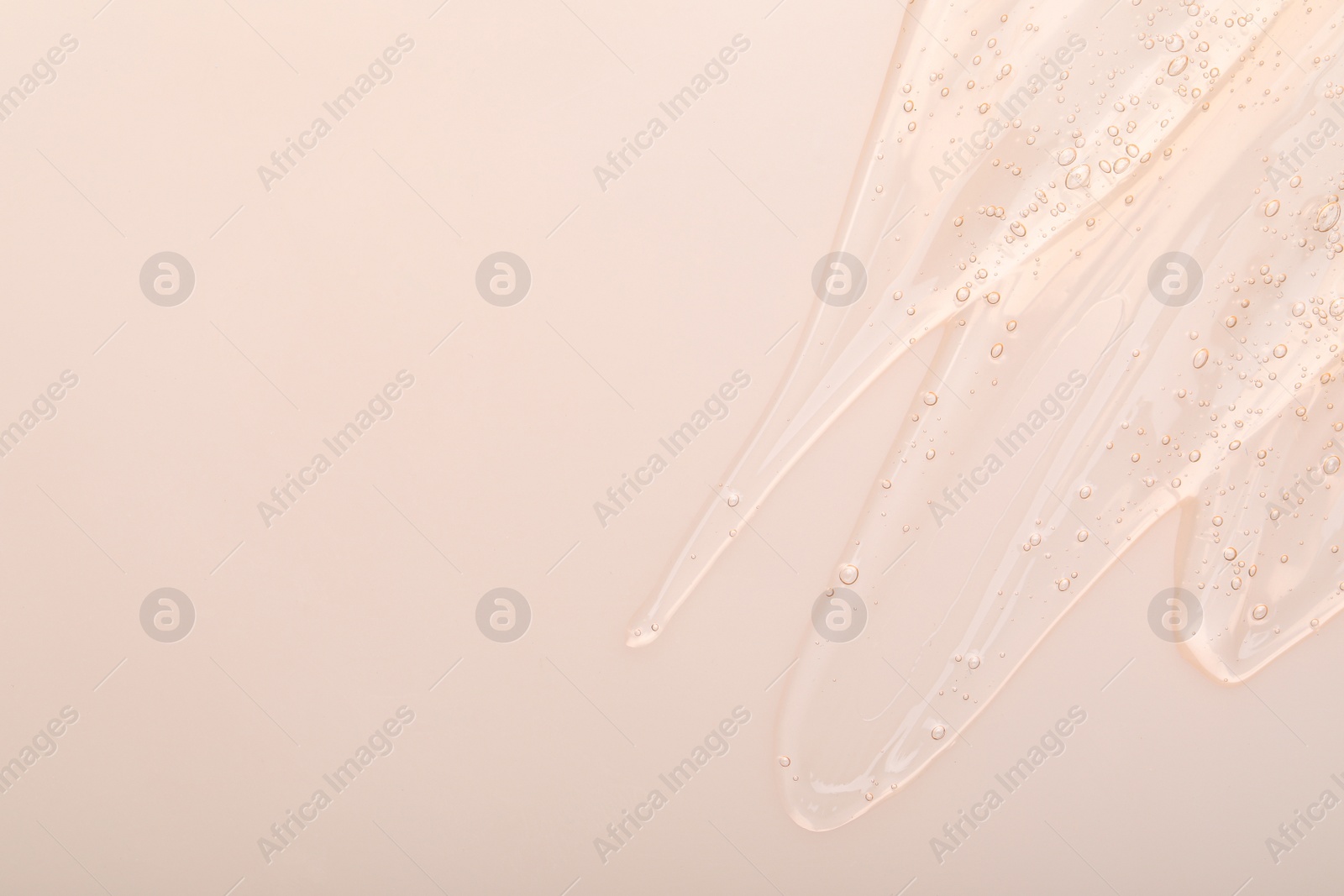 Photo of Pure transparent cosmetic gel on beige background, top view