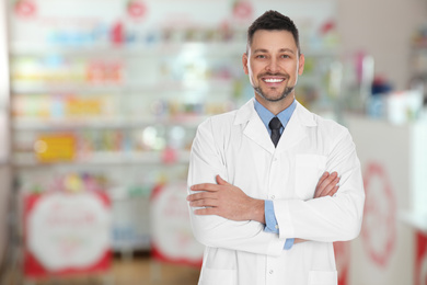 Professional pharmacist in modern drugstore, space for text  
