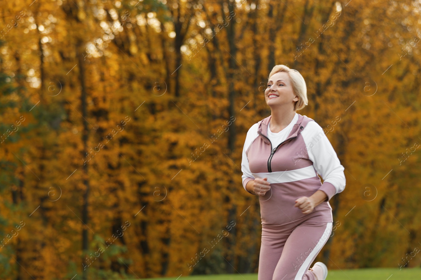 Photo of Mature woman jogging in park. Active lifestyle