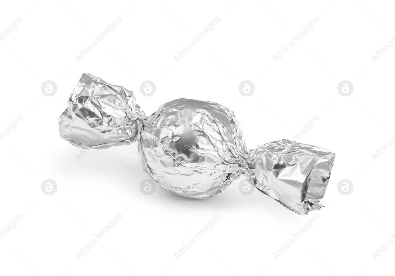 Photo of Tasty candy in silver wrapper isolated on white