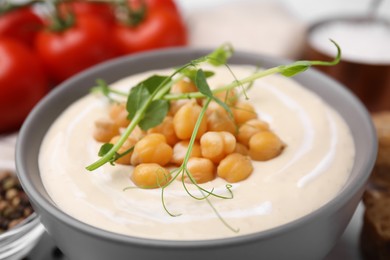 Photo of Tasty chickpea soup in bowl on table, closeup