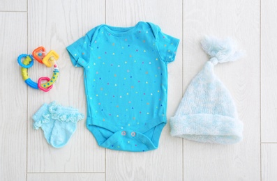 Photo of Flat lay composition with fashionable children's clothes on wooden background