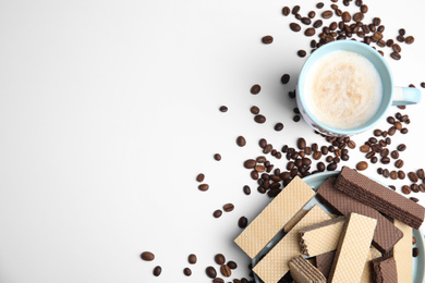 Breakfast with delicious wafers and coffee on white background, flat lay. Space for text